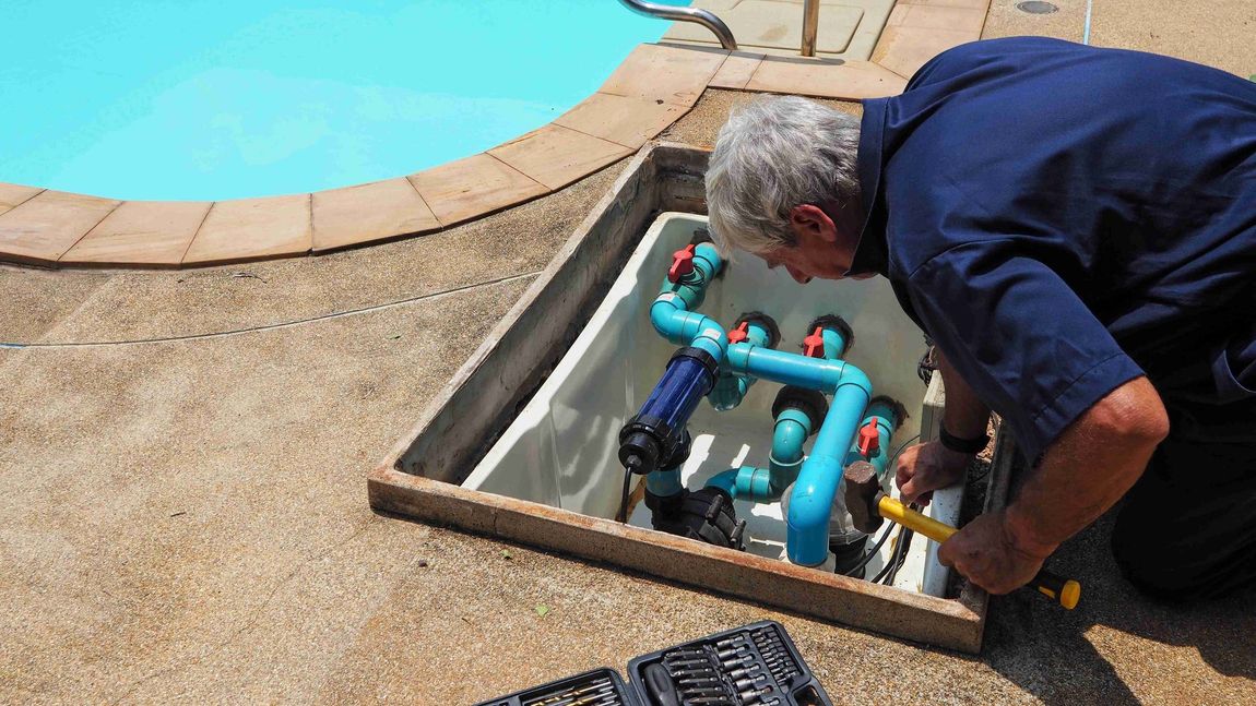 Man checking the mechanism of the pool