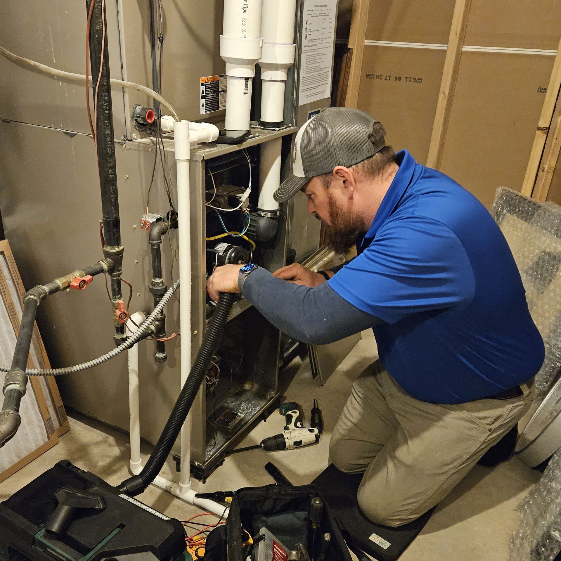 Technician from John's Heating, Cooling, and Appliance Repair working on a gas furnace in Peachtree City, ga.