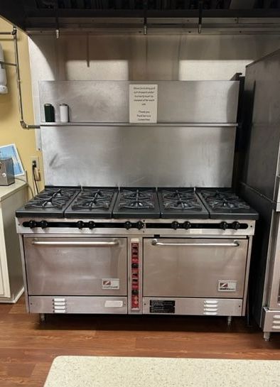 A large stainless steel stove and oven in a kitchen.