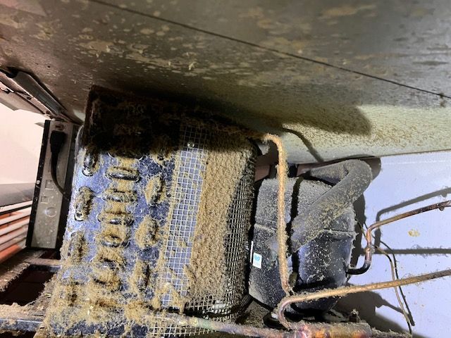 A close up of a dirty machine with a lot of dust on it.