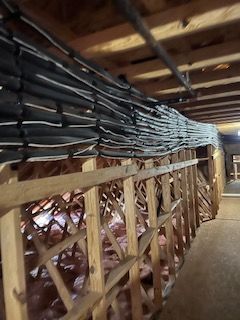 A bunch of wires are hanging from the ceiling of a building.