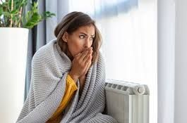 woman sitting in cold home because furnace is not working