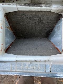 Evaporator Coil Removed From a Air Handler by John's Heating, Cooling, and Appliance Repair is stopped up with dirt
