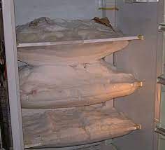 Inside of a  freezer is covered with ice 
