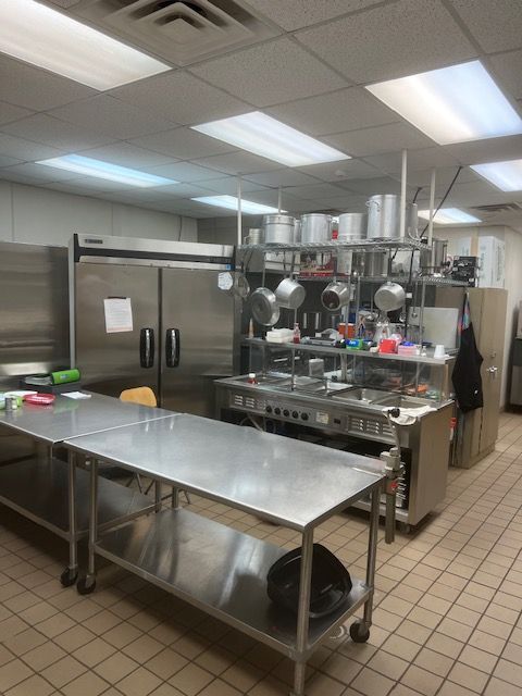 A kitchen with stainless steel appliances and a large table