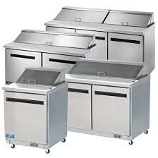 A group of stainless steel refrigerators are sitting next to each other on a white background.