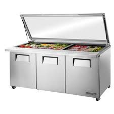 A stainless steel salad bar with a glass top.
