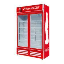 A red coca cola refrigerator with two glass doors on a white background.