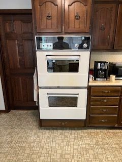 A kitchen with two ovens stacked on top of each other.