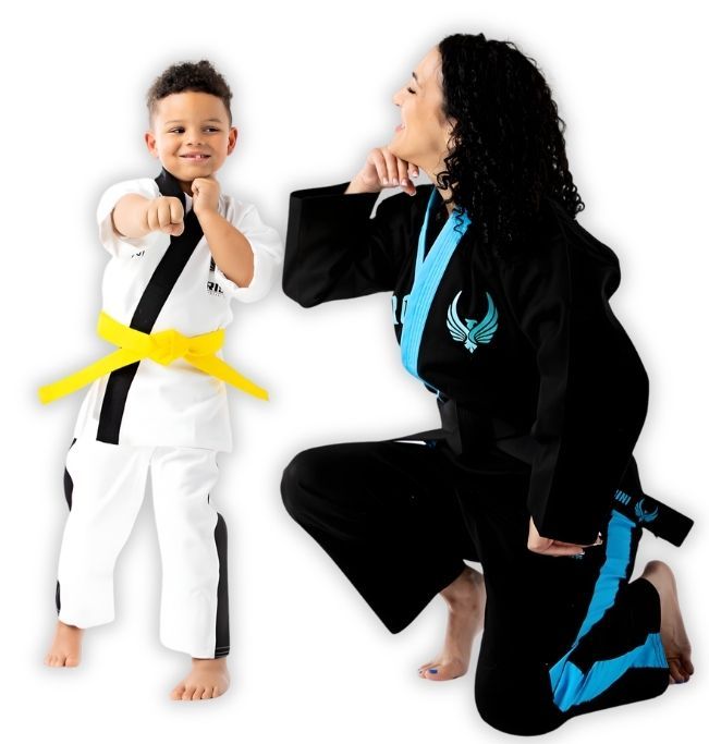 Man pointing, smiling, wearing black hoodie; arm tattoo visible.