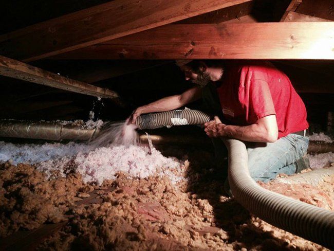 Fiberglass — Worker Installing Fiber Insulation in Hot Springs, AR