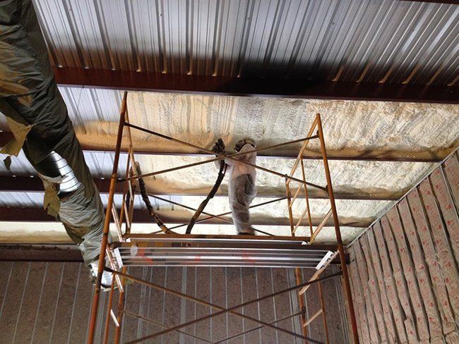 Worker Installing Foam Insulation — Hot Springs, AR — Southern Insulation & Gutters Inc