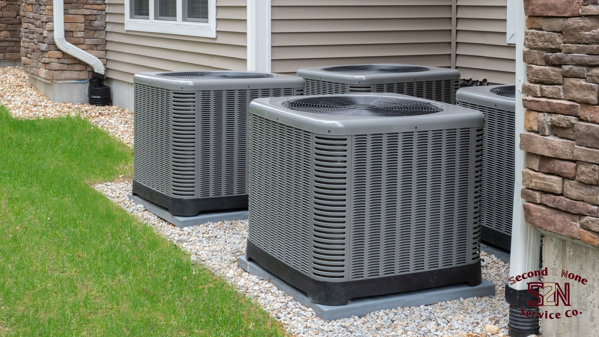 Three air conditioners are sitting outside of a house in Columbus Ga.