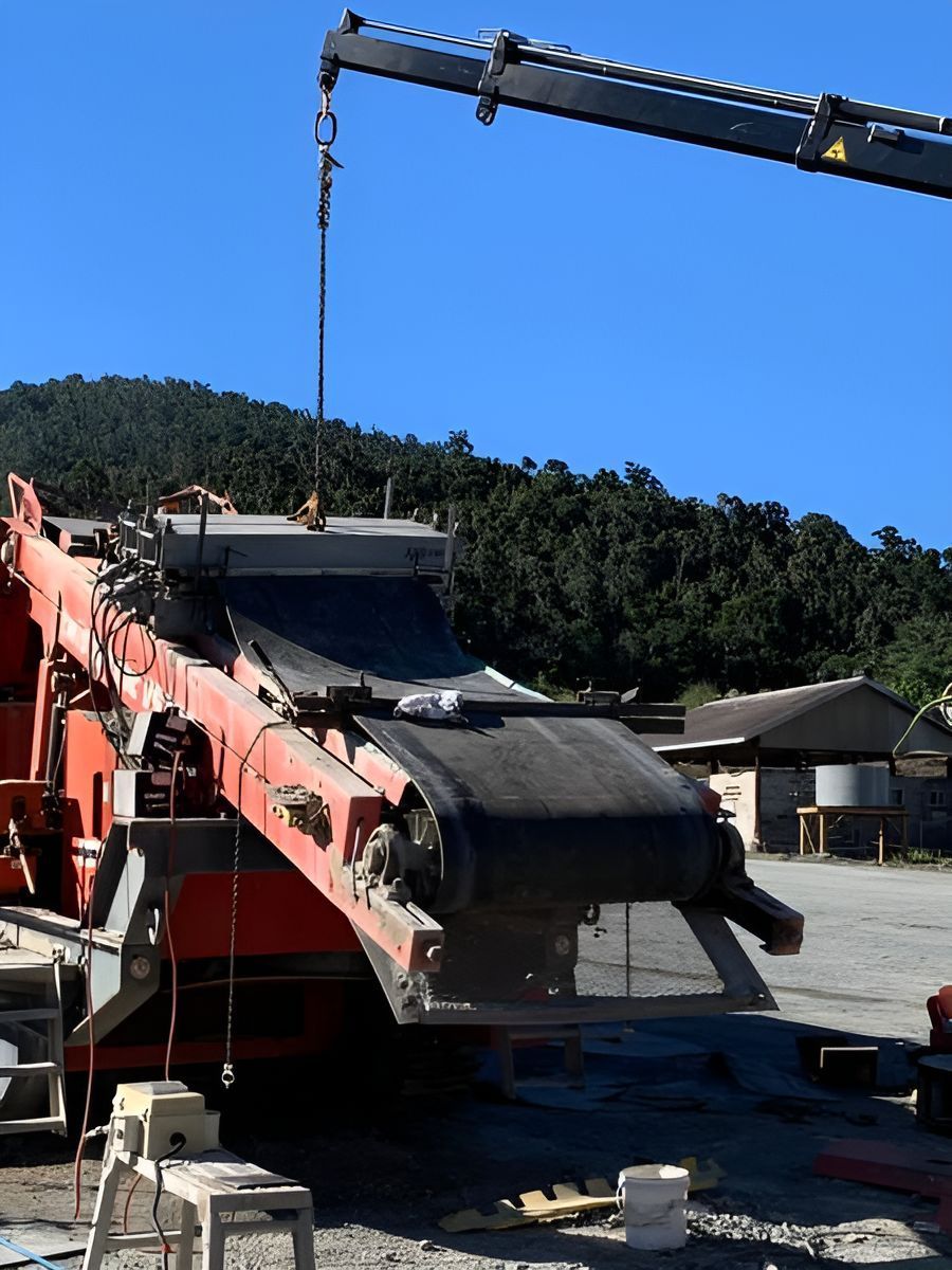 A Large Conveyor Belt Is Being Lifted By A Crane — Belt Maintenance & Supplies Pty Ltd In Nindaroo, QLD