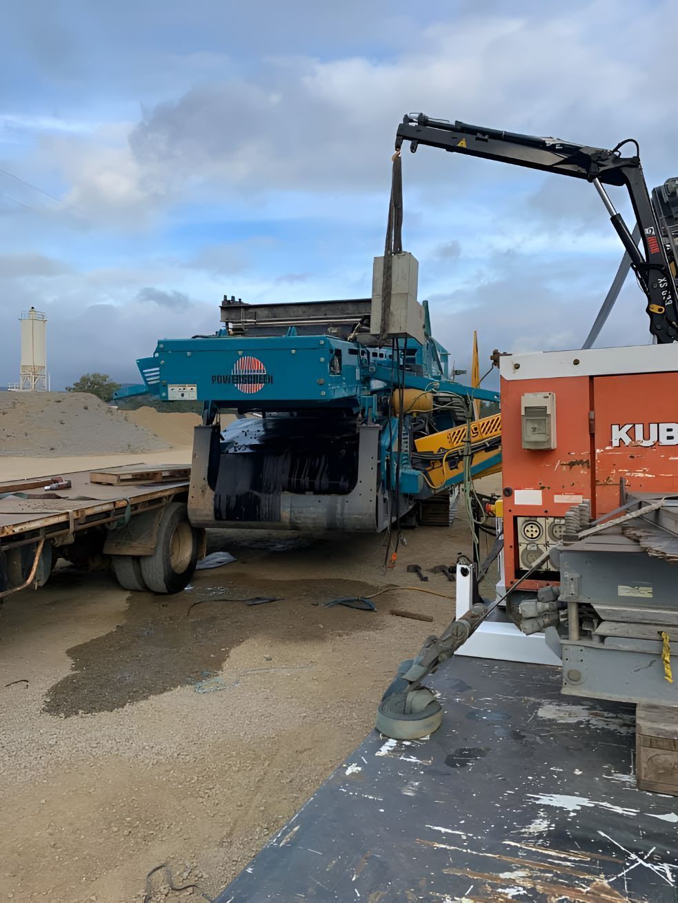 A Crane Is Lifting A Large Piece Of Equipment On Top Of A Truck — Belt Maintenance & Supplies Pty Ltd In Nindaroo, QLD