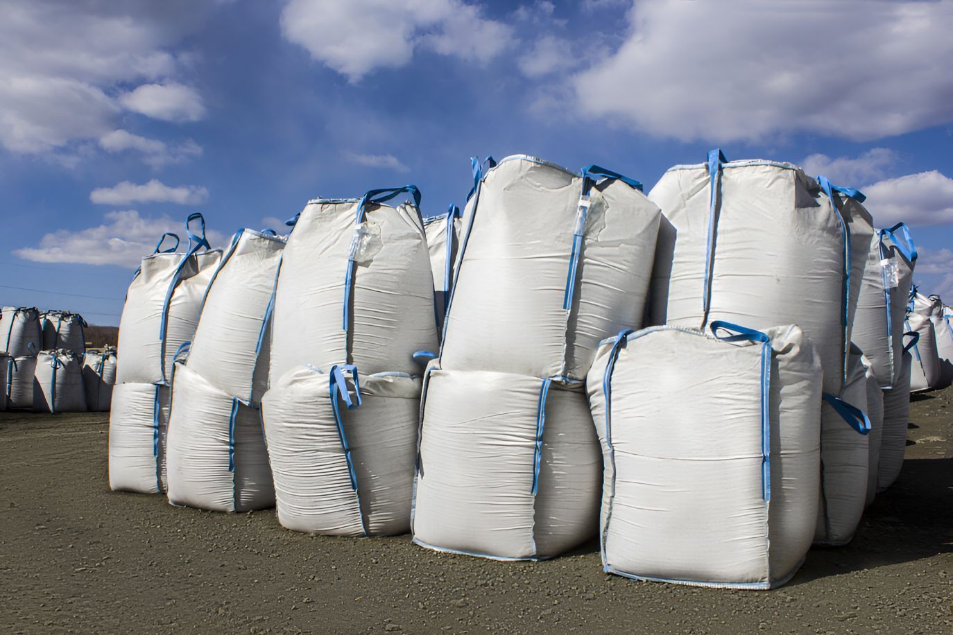 A Bunch Of White Bags Are Stacked On Top Of Each Other On The Ground — Belt Maintenance & Supplies Pty Ltd In Nindaroo, QLD