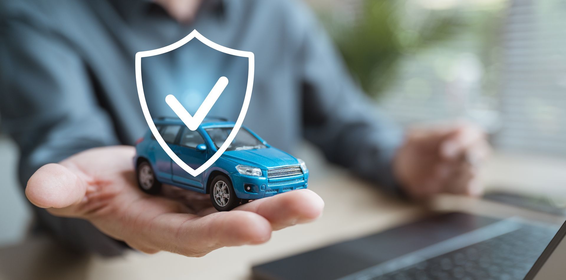Person holding a blue toy car with a shield and checkmark symbol overlay.