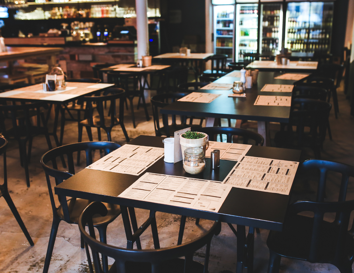 There are many tables and chairs in the restaurant.