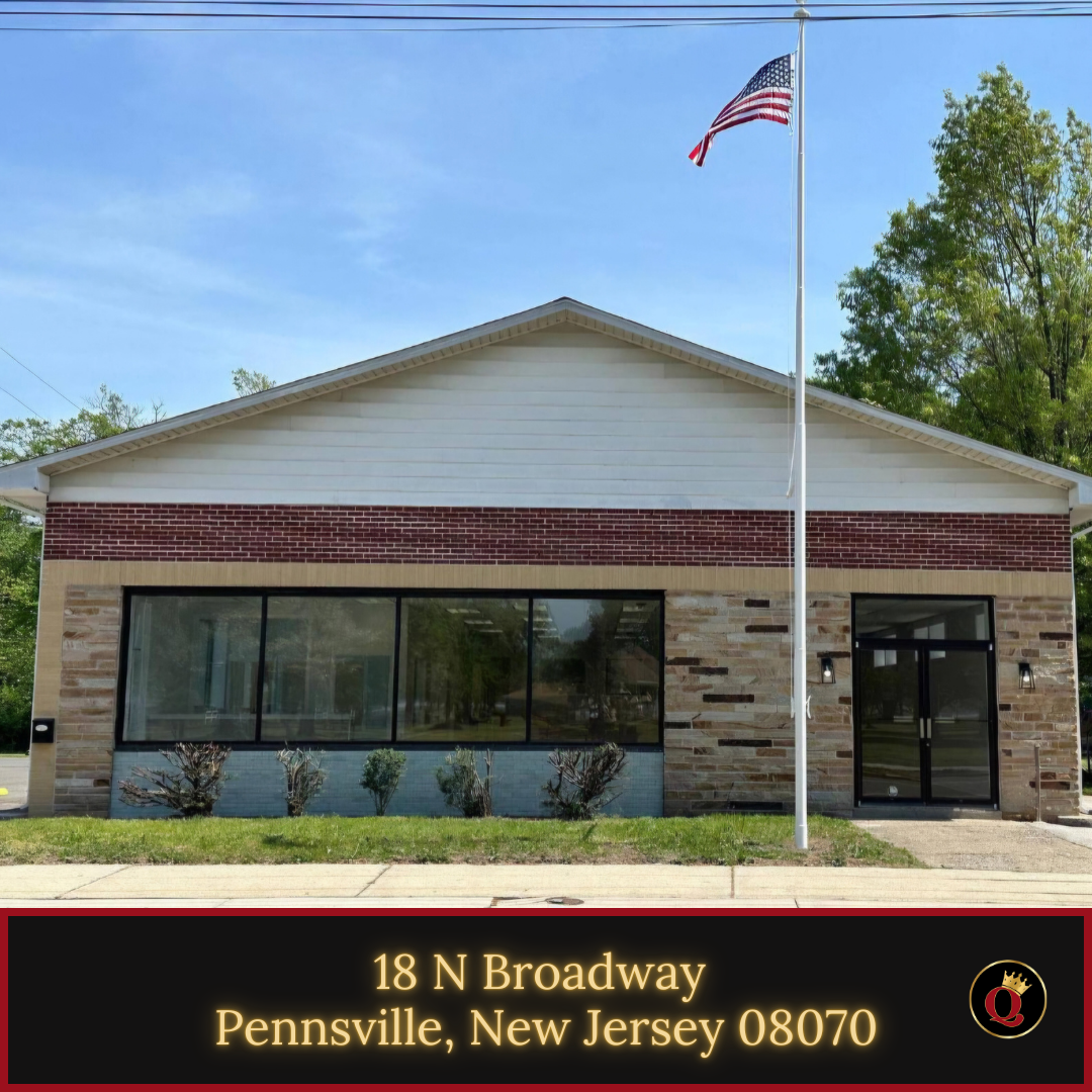 An american flag is flying in front of a building in pennsville new jersey