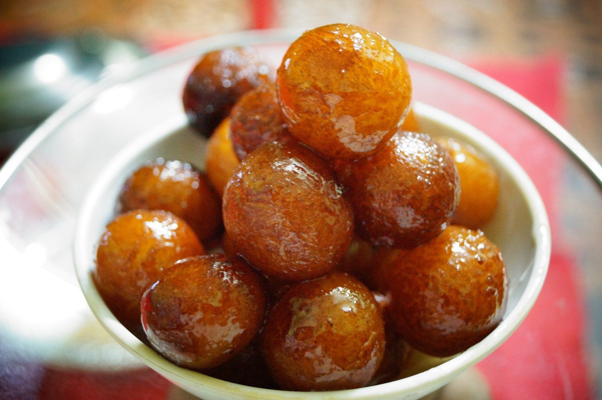 A white bowl filled with brown balls on a table.
