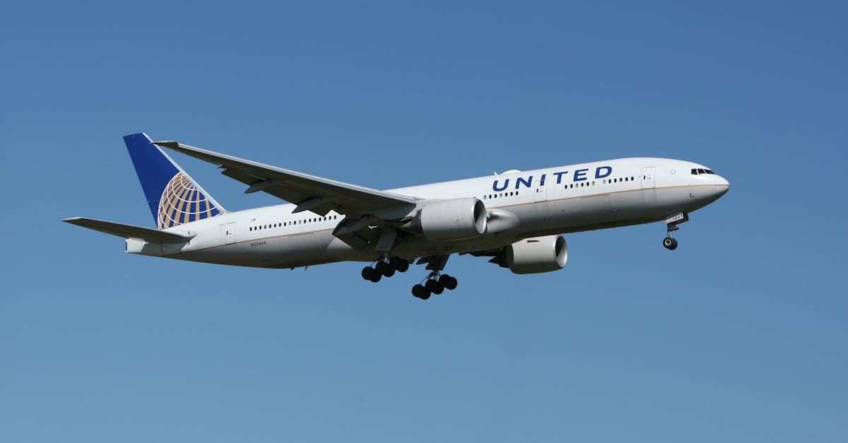 A united airlines plane is flying in the sky.