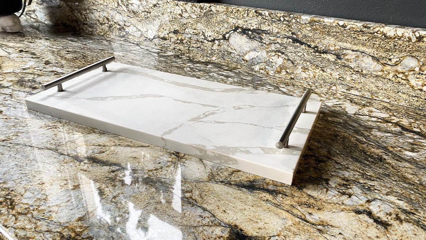 A white tray is sitting on top of a granite counter.