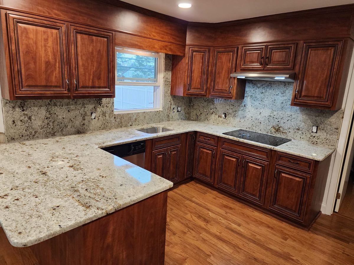 A kitchen with wooden cabinets and granite counter tops.
