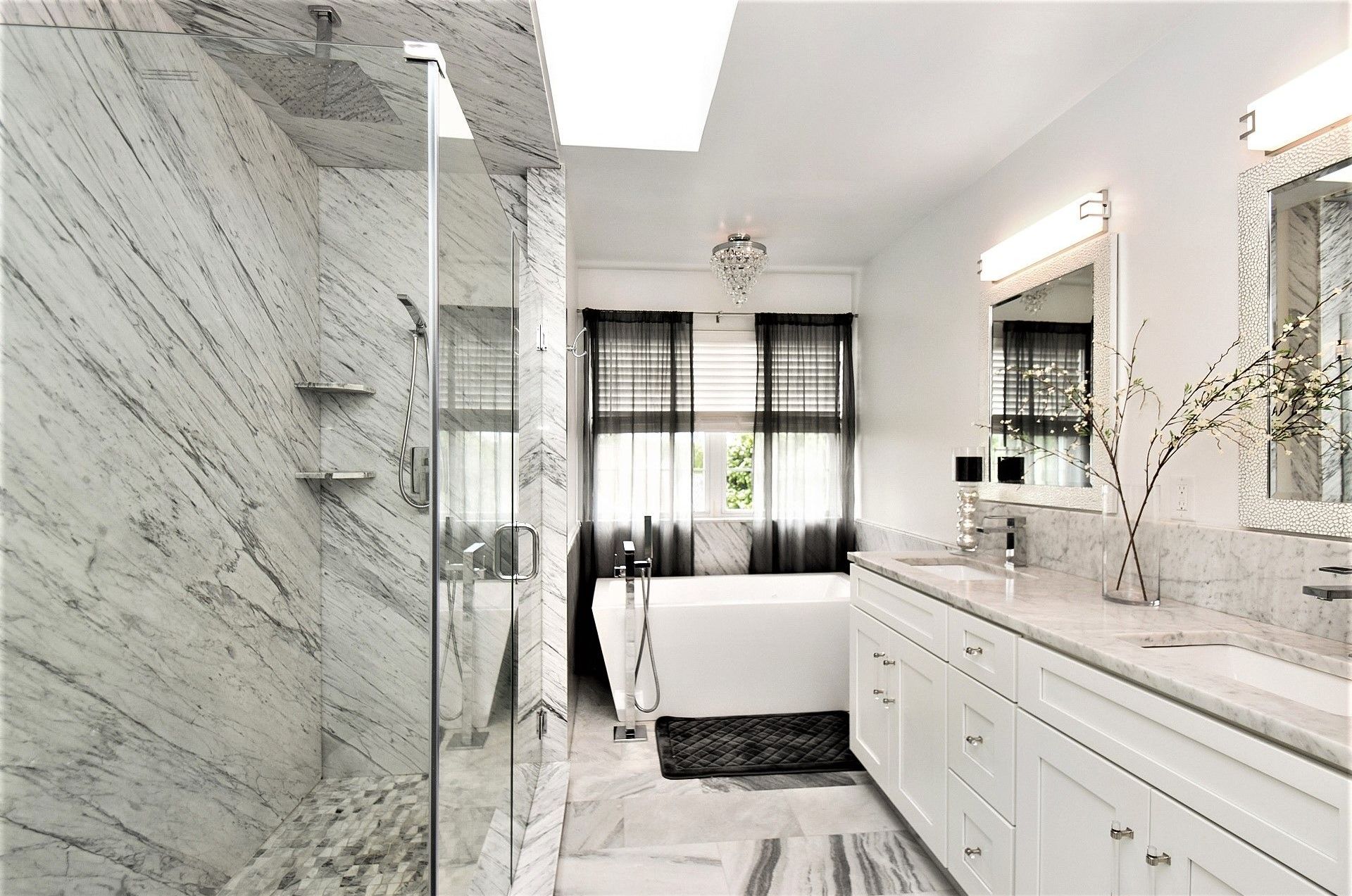 A bathroom with a tub , sinks , and a walk in shower.
