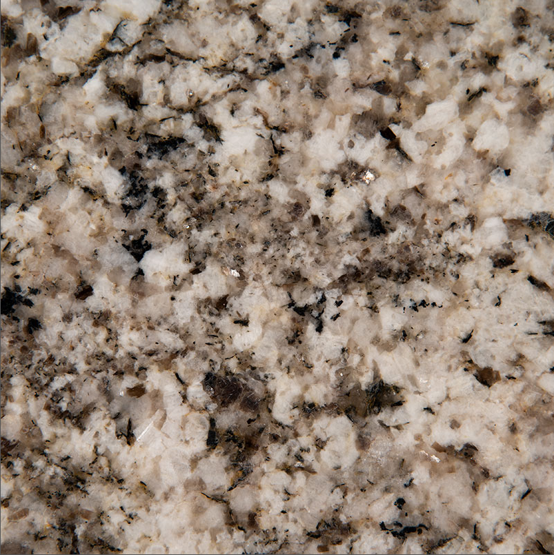 A close up of a brown and white granite surface
