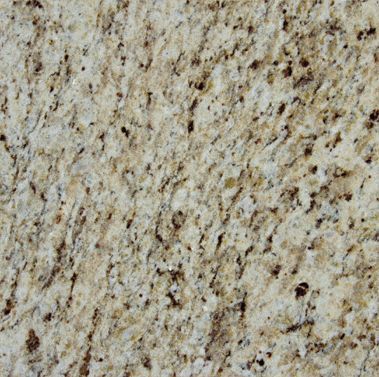 A close up of a white granite counter top with brown spots.