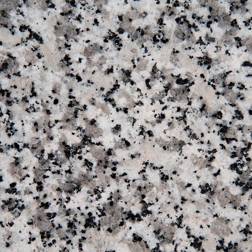 A close up of a granite surface with black and white spots