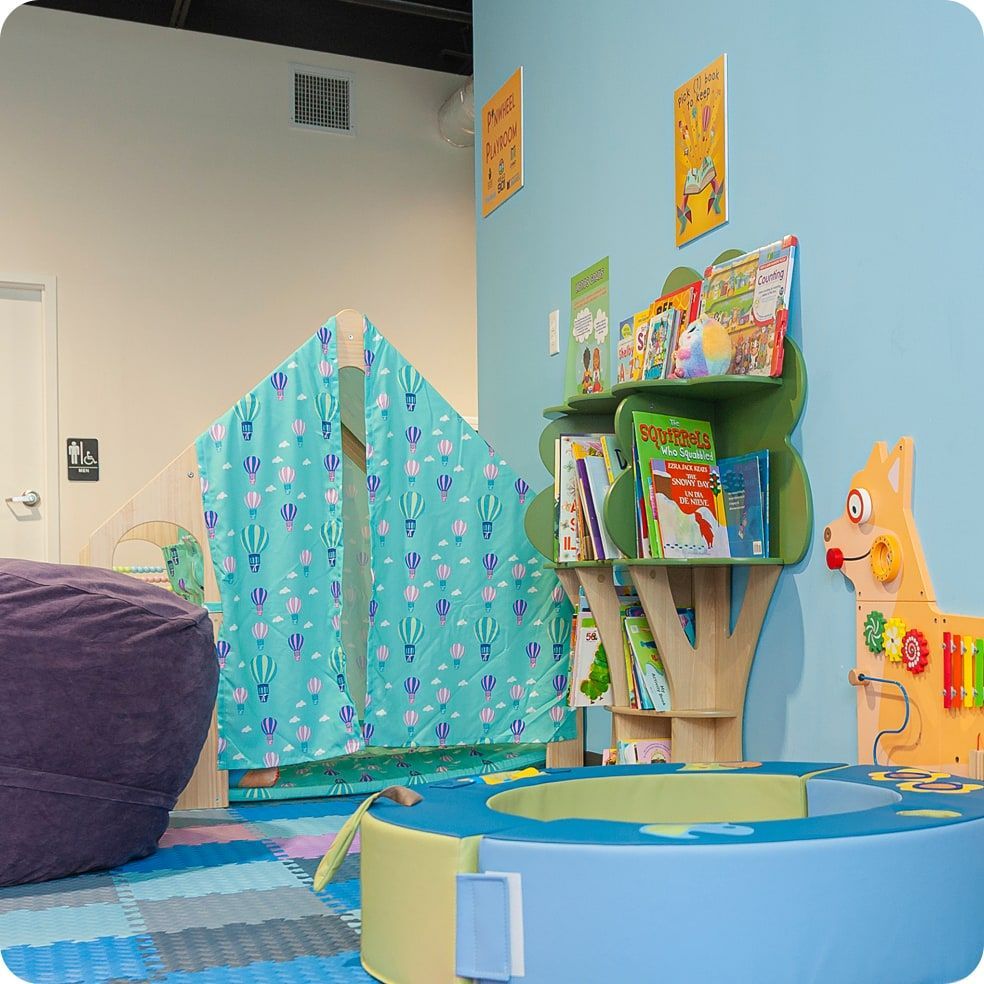 Laundromat in Memphis, TN with a Playroom with a tent, bookshelf, beanbag, and a small play area for families with small children.