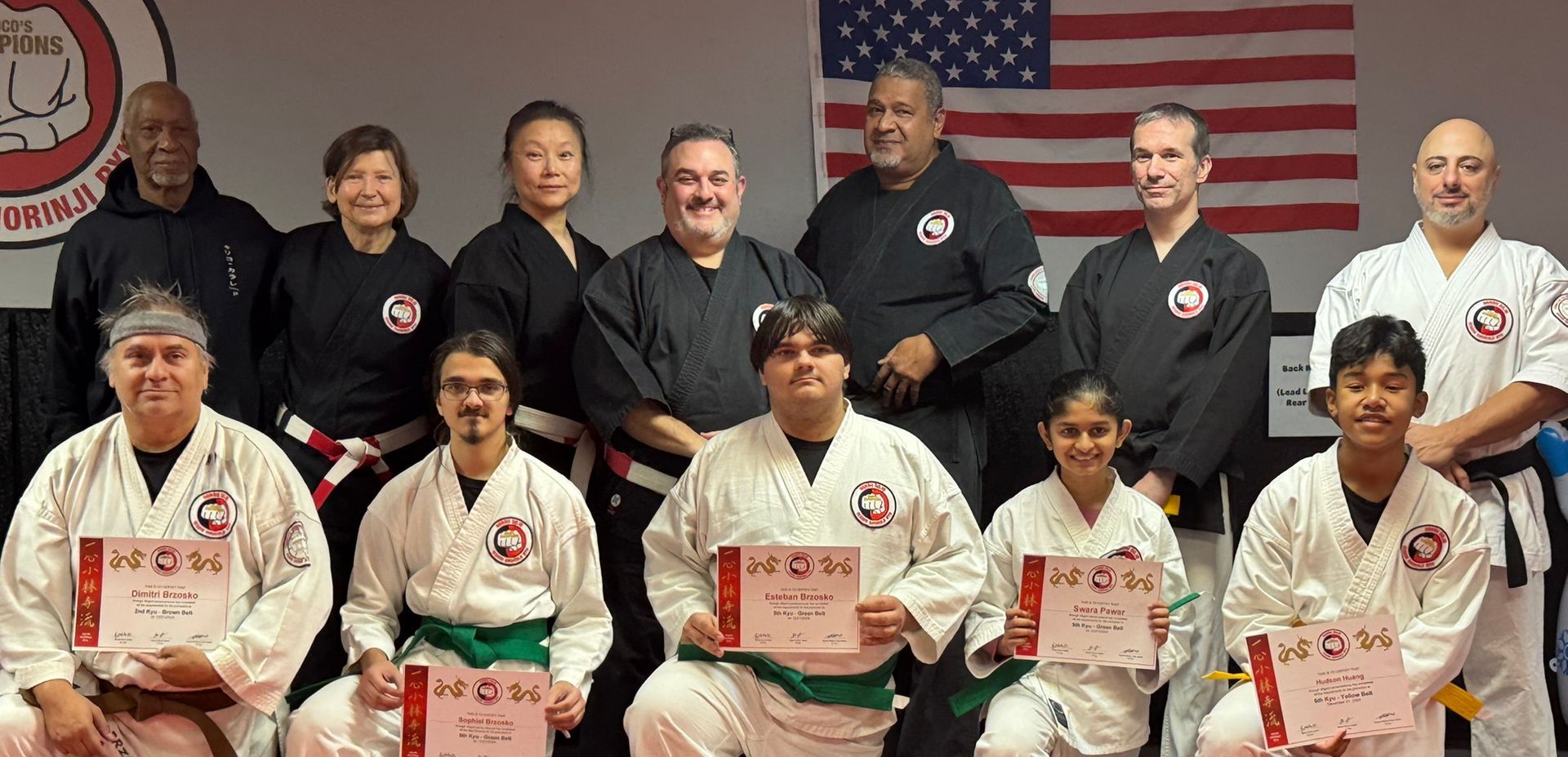 two men in blue and white kimonos are wrestling on a mat