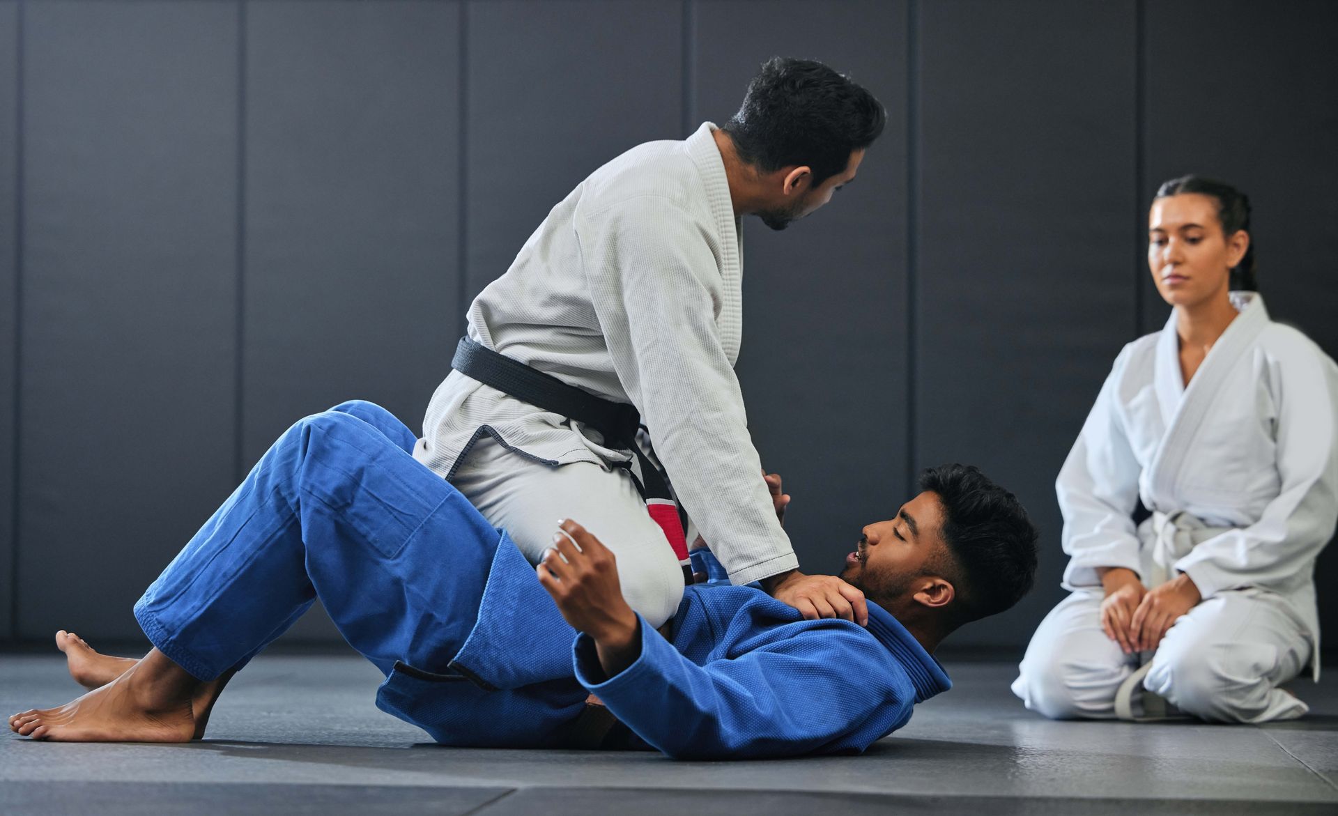 a group of people are practicing judo in a gym .