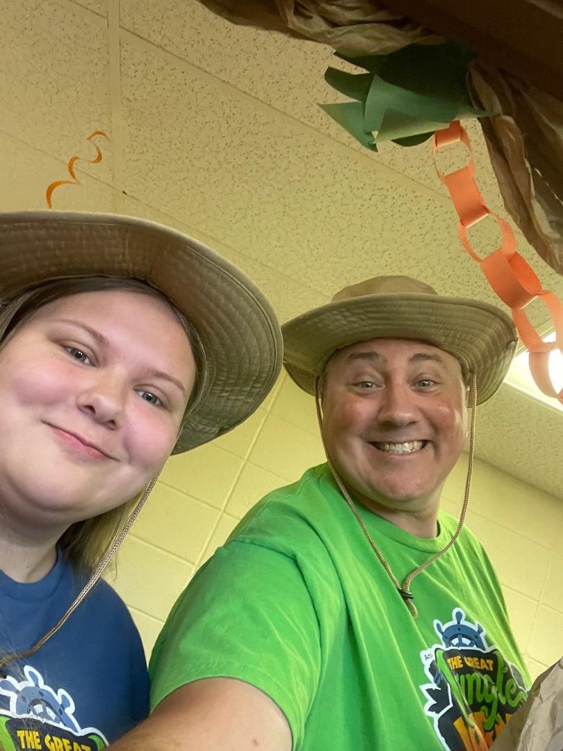 A man and a woman are posing for a picture while wearing hats.