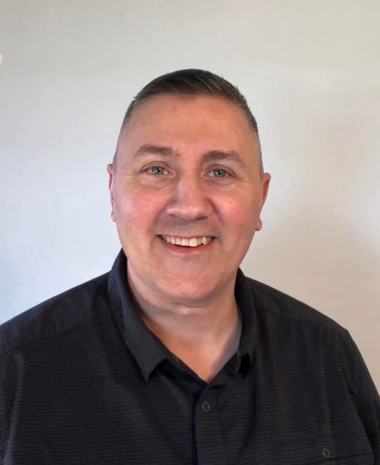 A man is smiling for the camera.