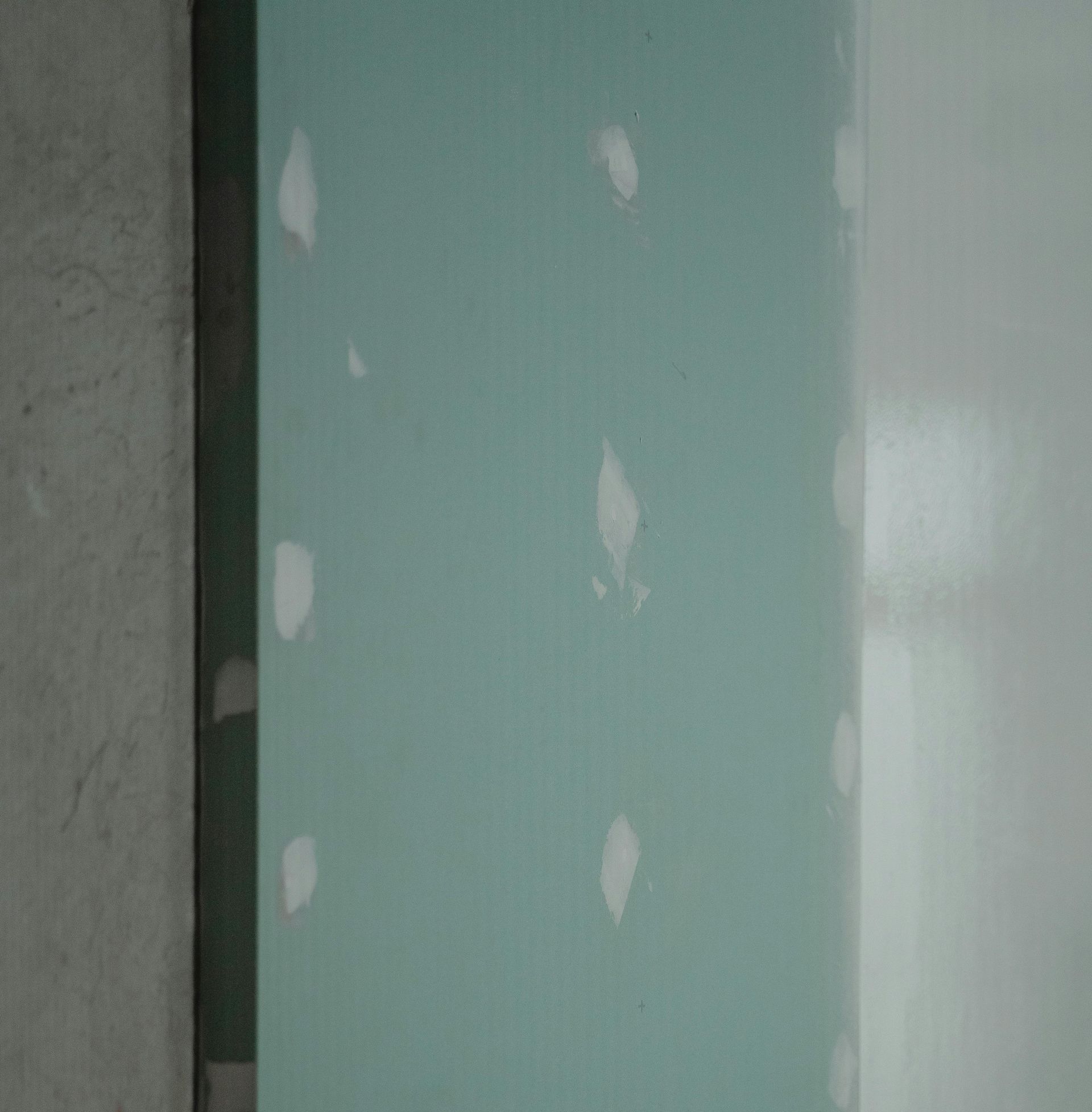 A close up of a piece of drywall on a wall.