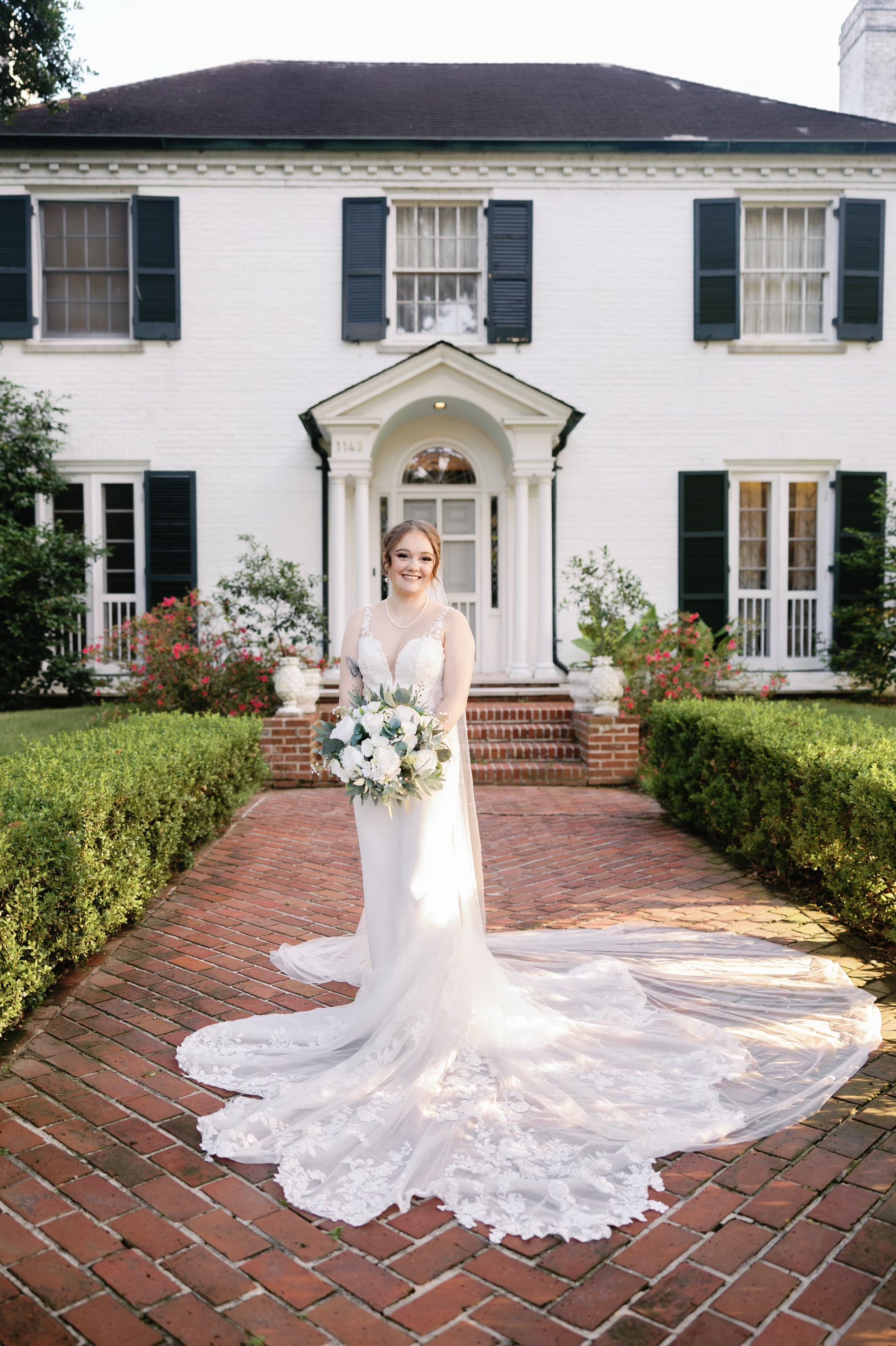 People with arms raised in a smoky club, lit with blue and red hues.