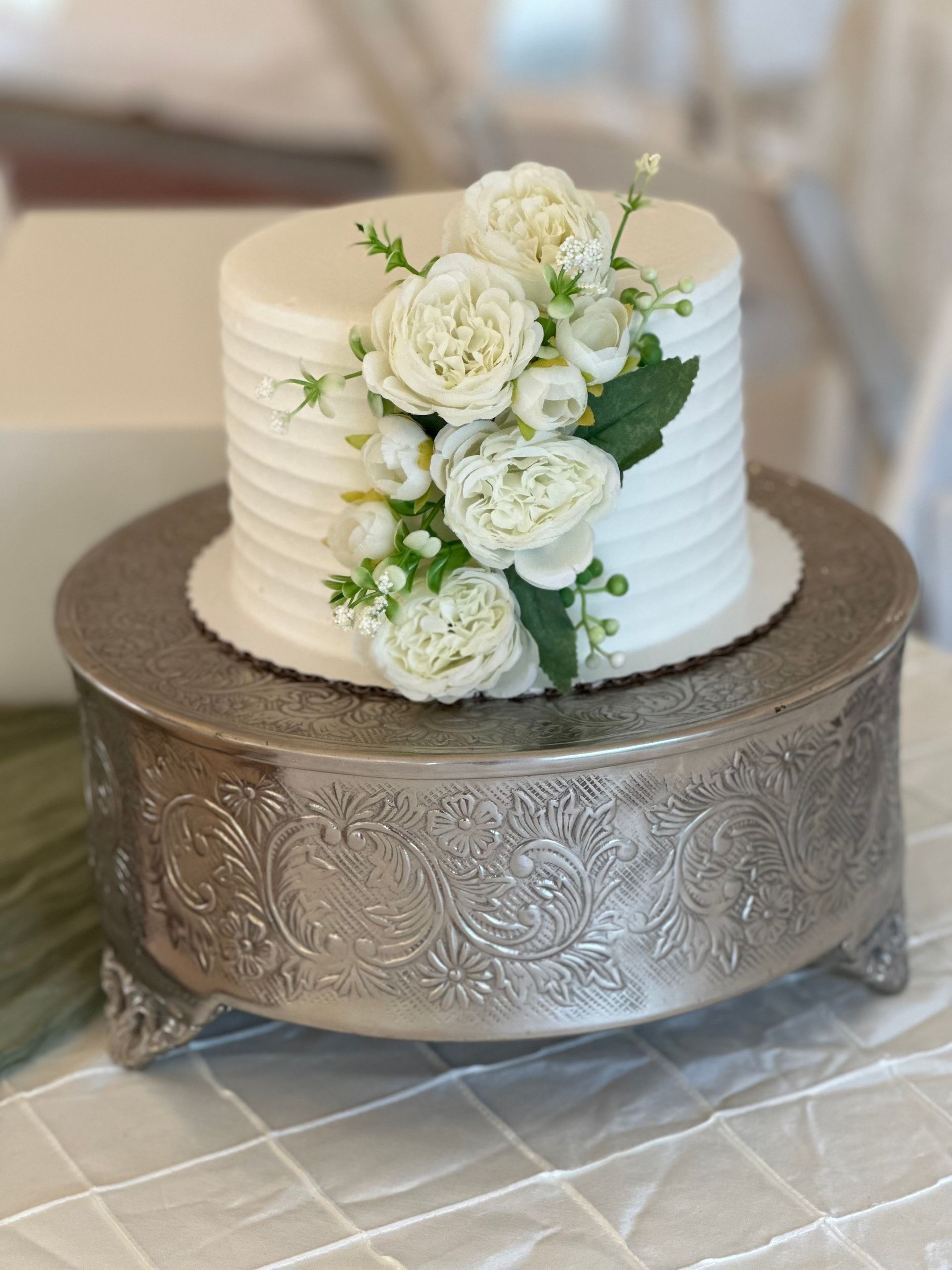 Groom in gray suit and pink tie, showered with confetti after wedding ceremony.