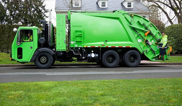 A Green Garbage Truck is Parked on the side of the Road | Garrettsville, OH | Leonard's Junk Removal