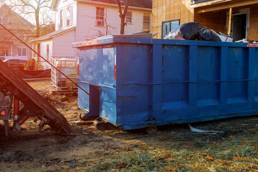 A Blue Dumpster is Sitting in Front of a House under Construction | Garrettsville, OH | Leonard's Junk Removal