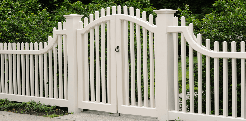 A white fence with a twin gate