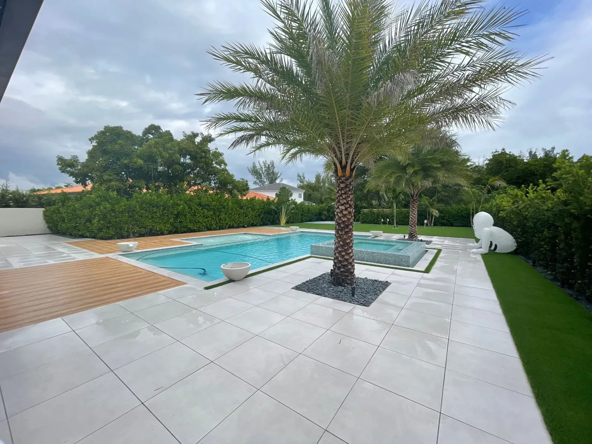 Custom luxury swimming pool with large paver deck by top swimming pool contractors in South Florida