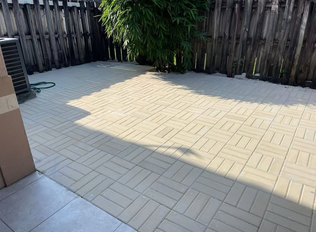 Custom patio construction with beige paver tiles by outdoor patio builders in South Florida