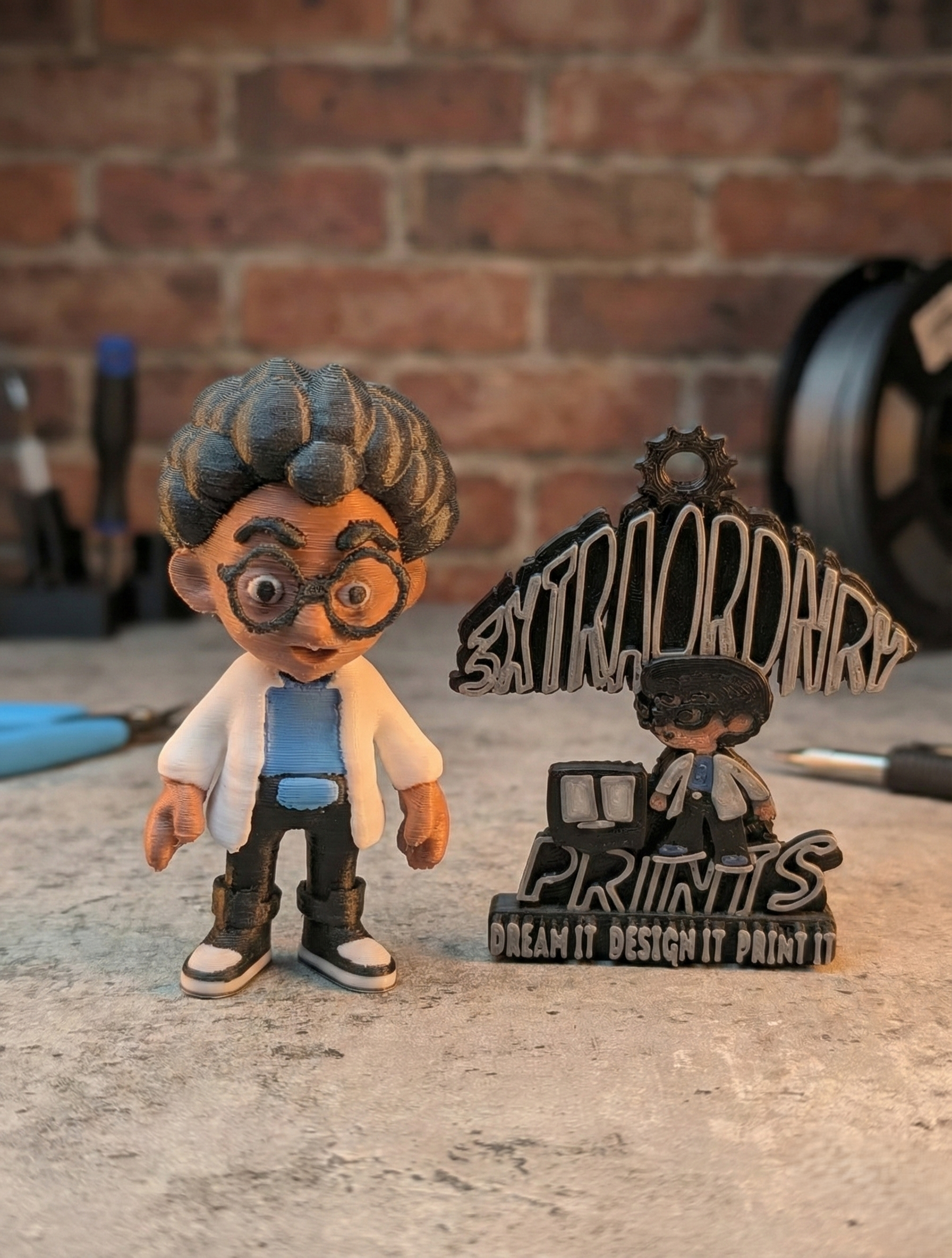 3D-printed figurine of a person wearing glasses and a lab coat next to a 3D-printed sign on a table.