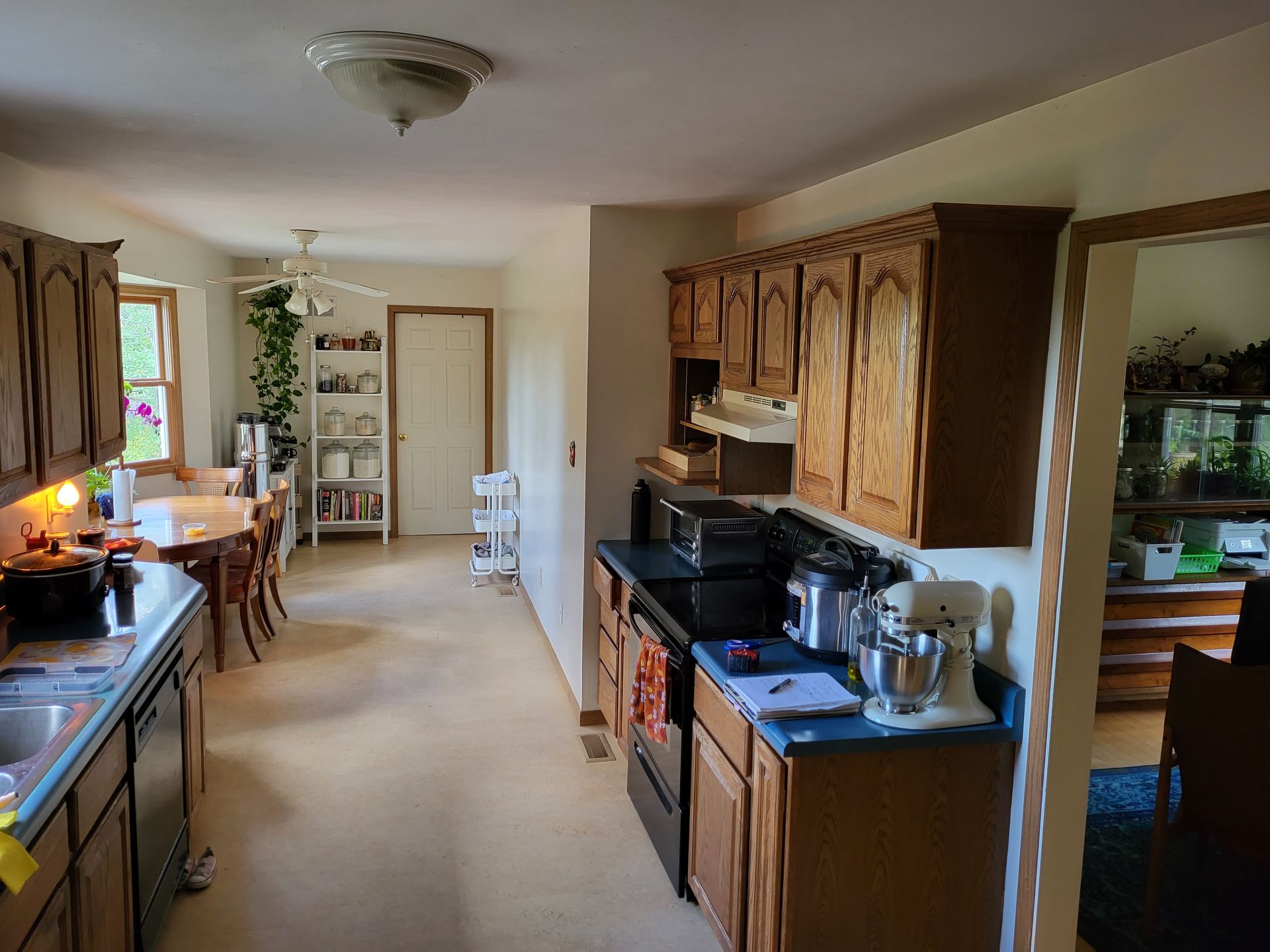 A kitchen with wooden cabinets and a black stove top oven