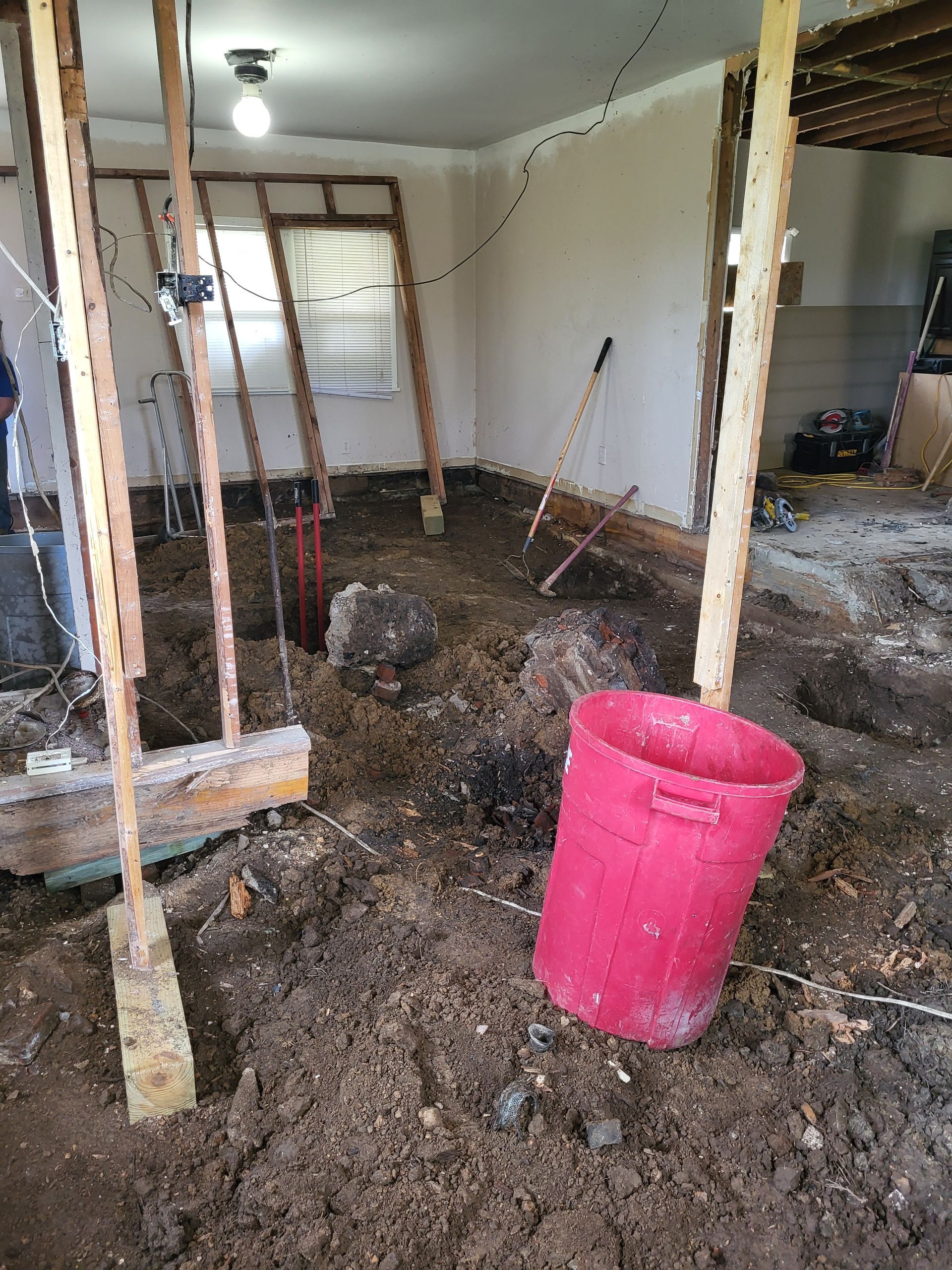 There is a red bucket in the middle of the room.