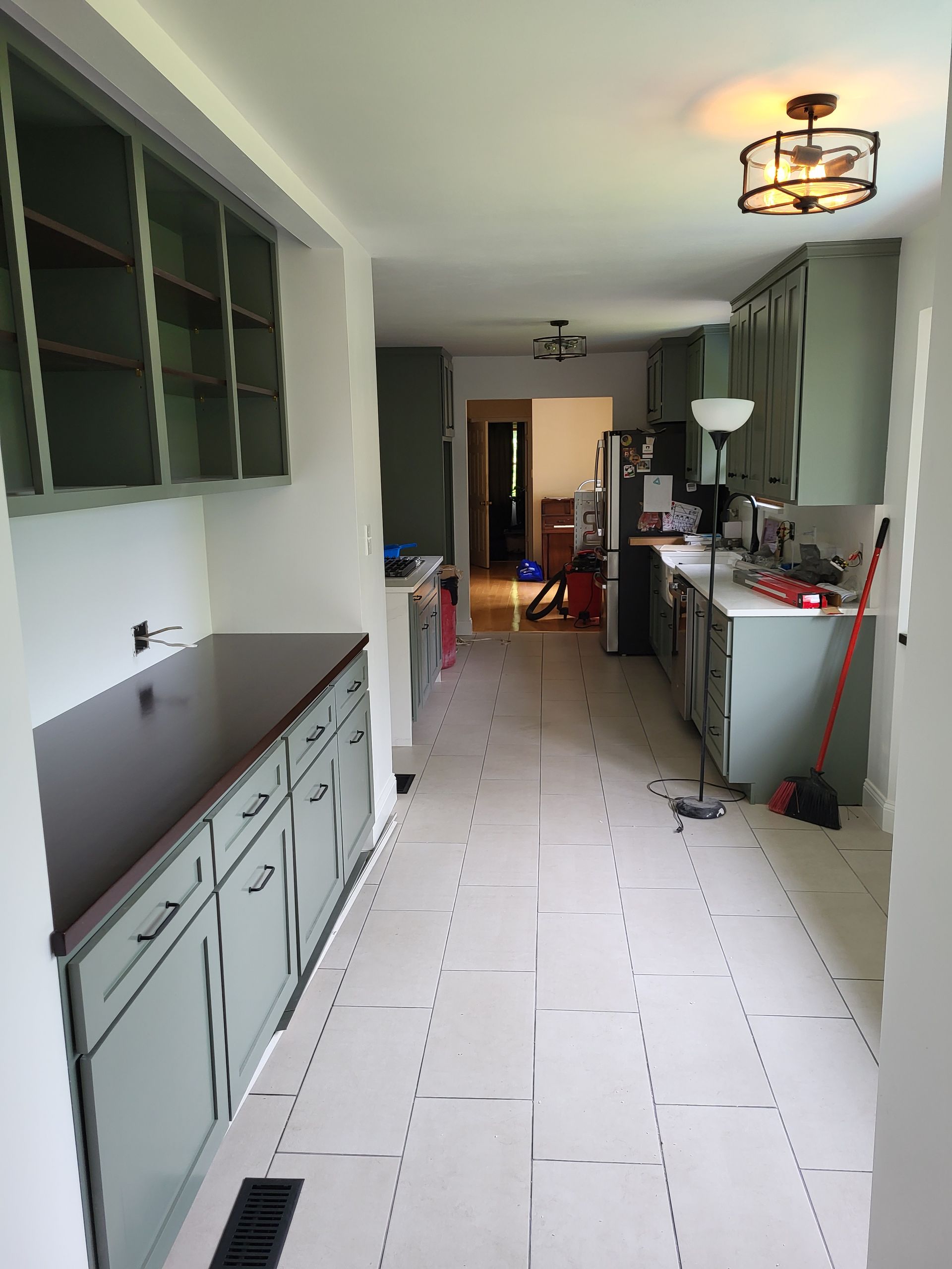A kitchen with a lot of cabinets and a ceiling light
