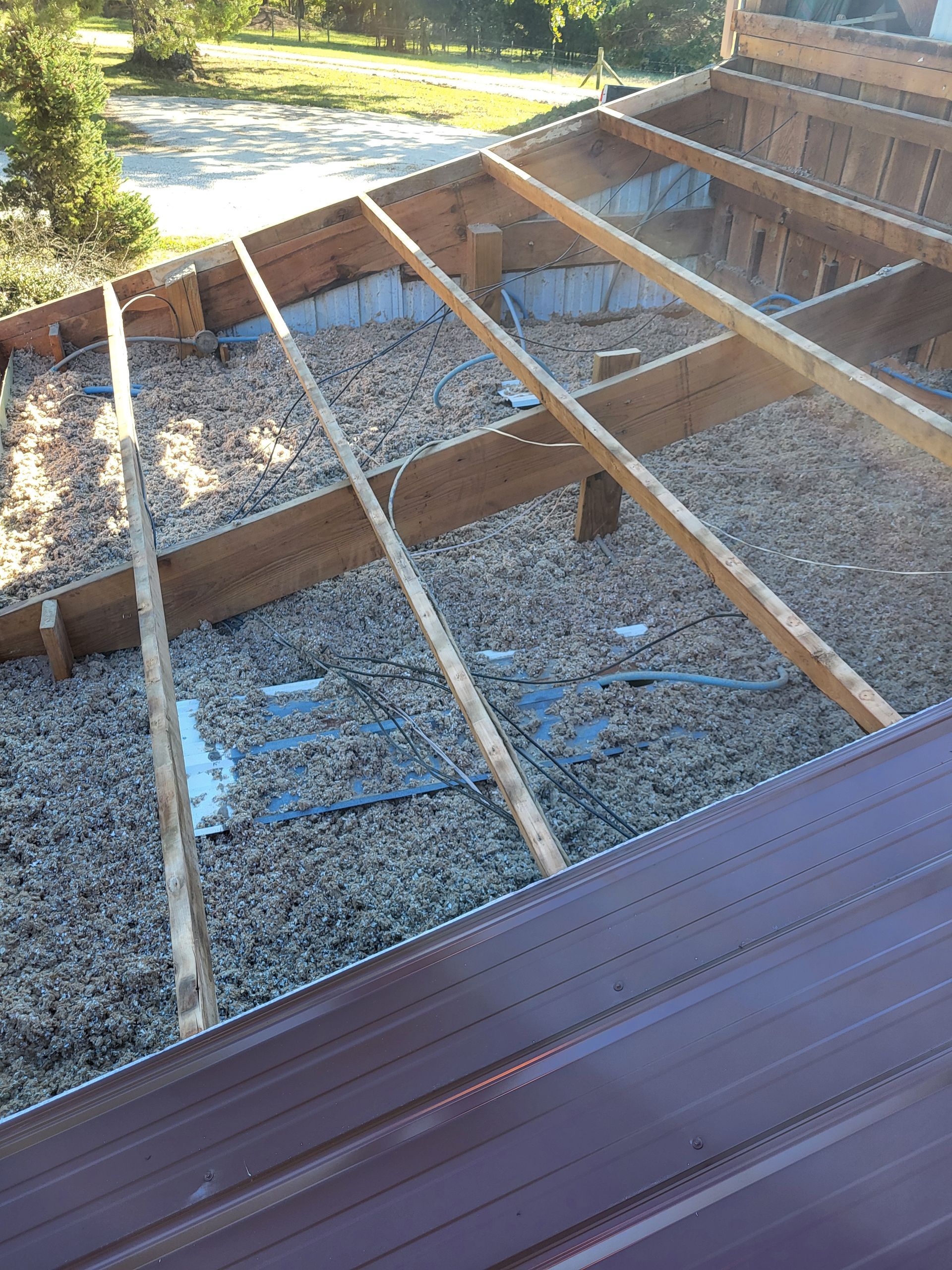 A wooden structure is being built on top of a pile of gravel.