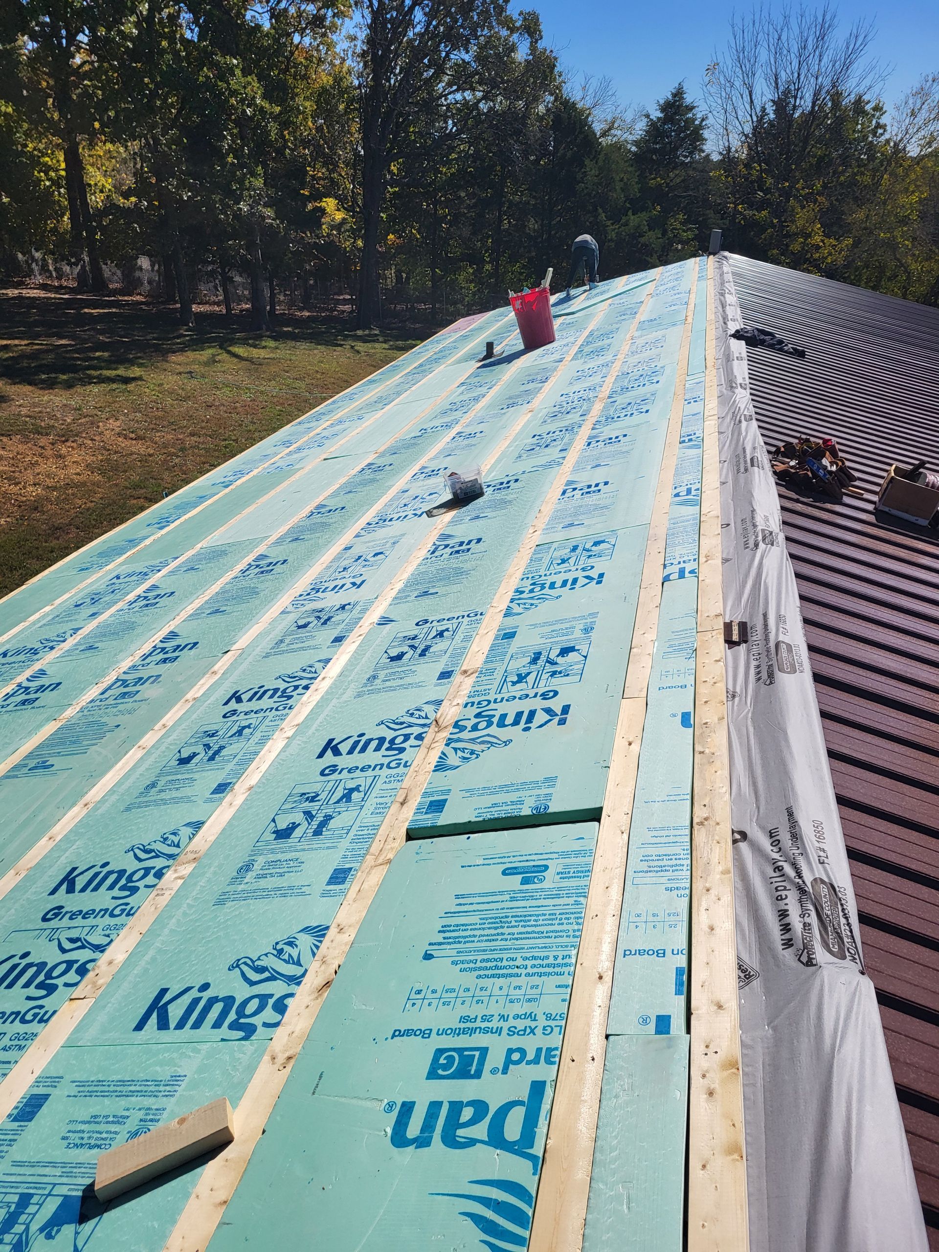A roof is being built with a lot of green foam on it.